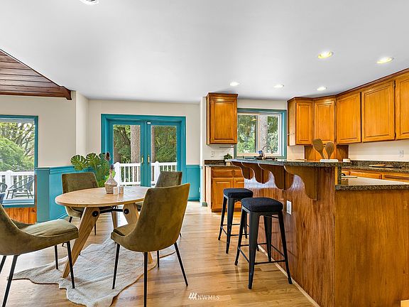 Granite counters, breakfast bar and room for casual dining in the kitchen