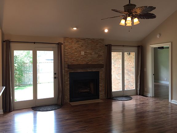 Large living room with french doorstop the private backyard