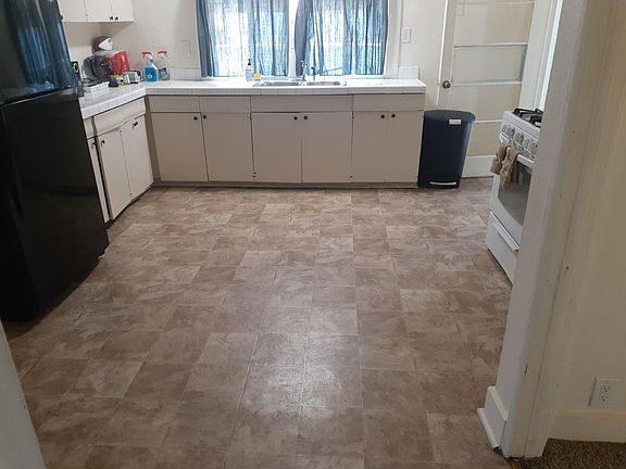 Large kitchen with refrigerator, stove/oven and microwave