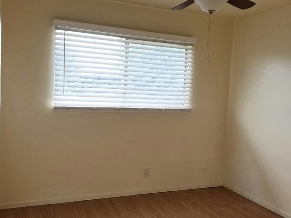 Bedroom #1- pretty spacious bedroom size with ceiling fan and faux wood blinds installed.