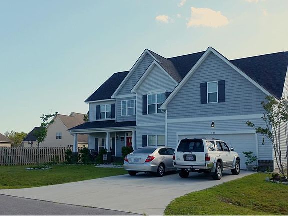 Front- covered patio, 2 car garage with work bench and storage space, blueberry bushes and strawberry patch.