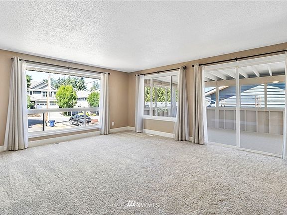 Let all that light in! Your living room is drenched with sunlight - accenting the fresh interior paint throughout. 