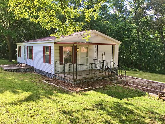 Side Covered Porch and Parking Area (Gravel)