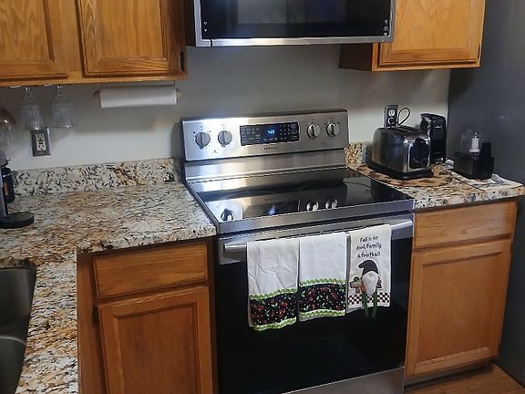 Kitchen with updated flooring, granite counter tops and newish applicances