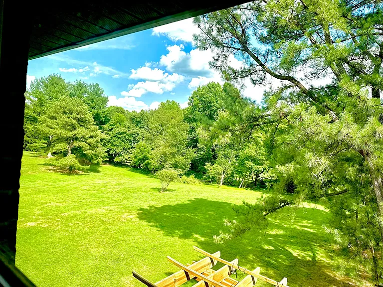 Imagine having a long or stressful day and waking up or coming home to this beautiful view of nature at its finest. This room offers peaceful scenic views of trees and flowers, creating a calm and refreshing atmosphere you can enjoy always.