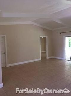 Dining Room : Dining and living room with cathedral ceilings, beams and crown molding.