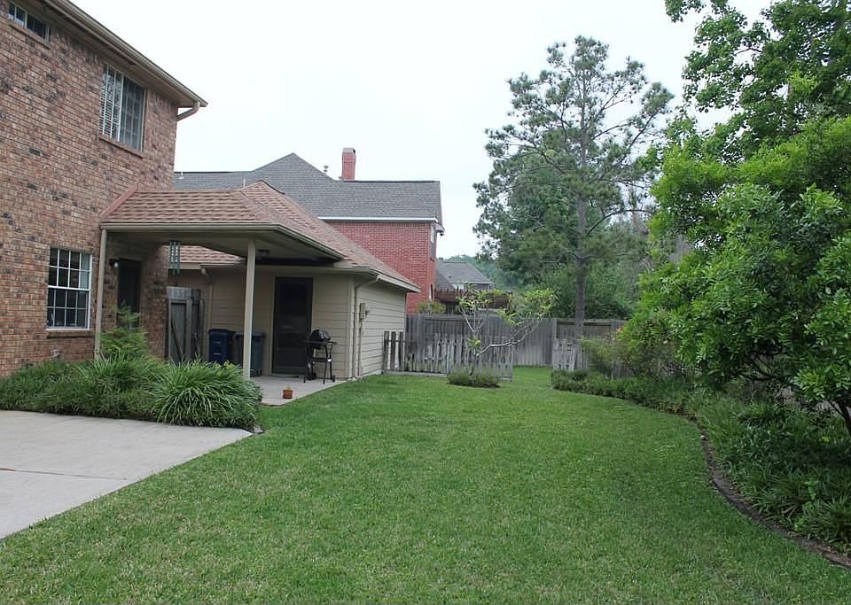 A look at the long backyard. Through the opening of the fence is MORE yard located behind the garage.