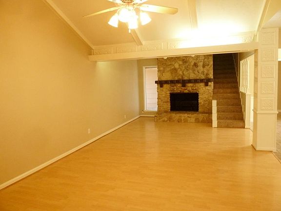 This spacious den features a beautiful stone fireplace and easy care laminate flooring.