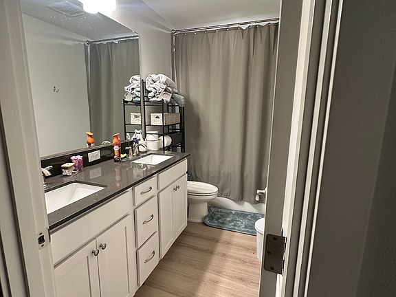 Shared bathroom with other tenants, equipped with his / her sinks, storage cabinets beneath each sink.