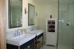 Master Bath has Modern Sinks and Huge Glass Tiled Shower with Numerous Heads