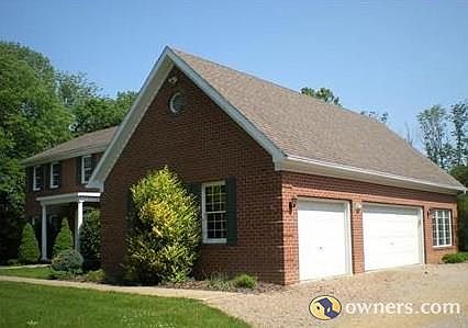 view from driveway of garage, sunroom.