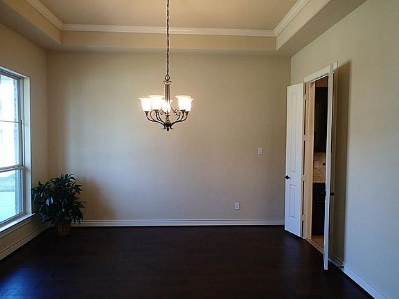 5" hand scraped wood floors in the formal dining room w/ d=crown molding & an oil rubbed bronze ligh