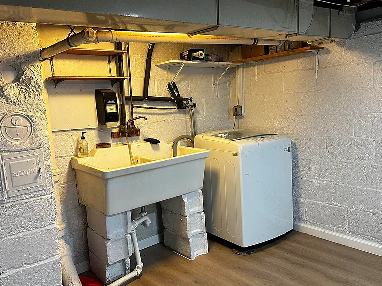 The ultimate laundry suite: waterproof LVP, bright lights, total comfort.