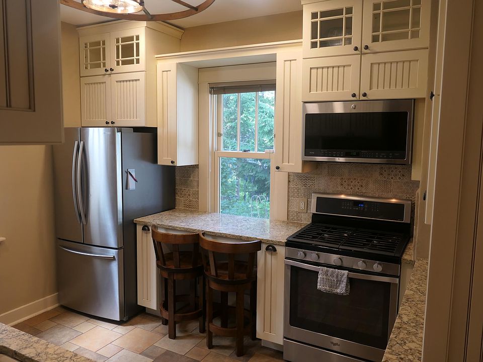 Breakfast bar overlooking the backyard, nestled between stainless-steel appliances.
