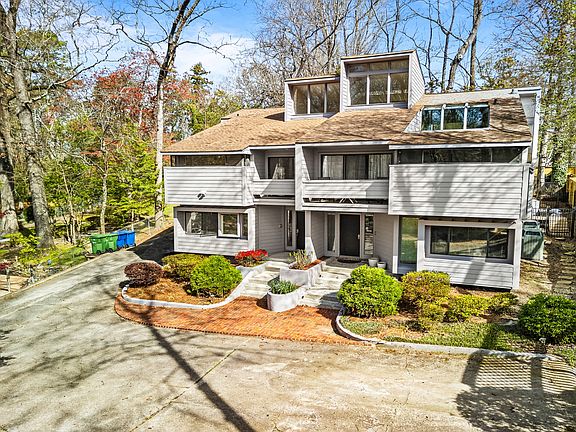 Mid-century modern hilltop home in Buckhead with a private driveway and two dedicated parking spaces right next to the townhome