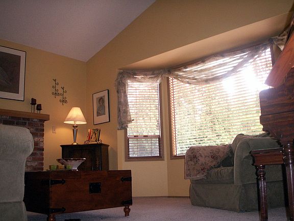 Formal Living Room has beautiful vaulted ceilings and wood burning fireplace