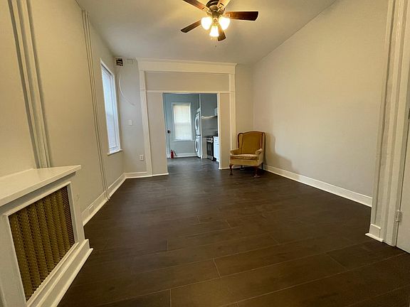 Wide angle view of living room and kitchen (taken while standing in corridor leading to bathroom/ bedroom)