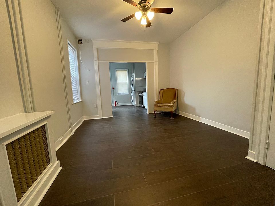 Wide angle view of living room and kitchen (taken while standing in corridor leading to bathroom/ bedroom)