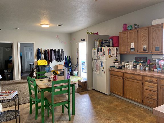 Eat-in kitchen and view of living area from the kitchen. Also, view of bedroom 1 and 2 entrance.
