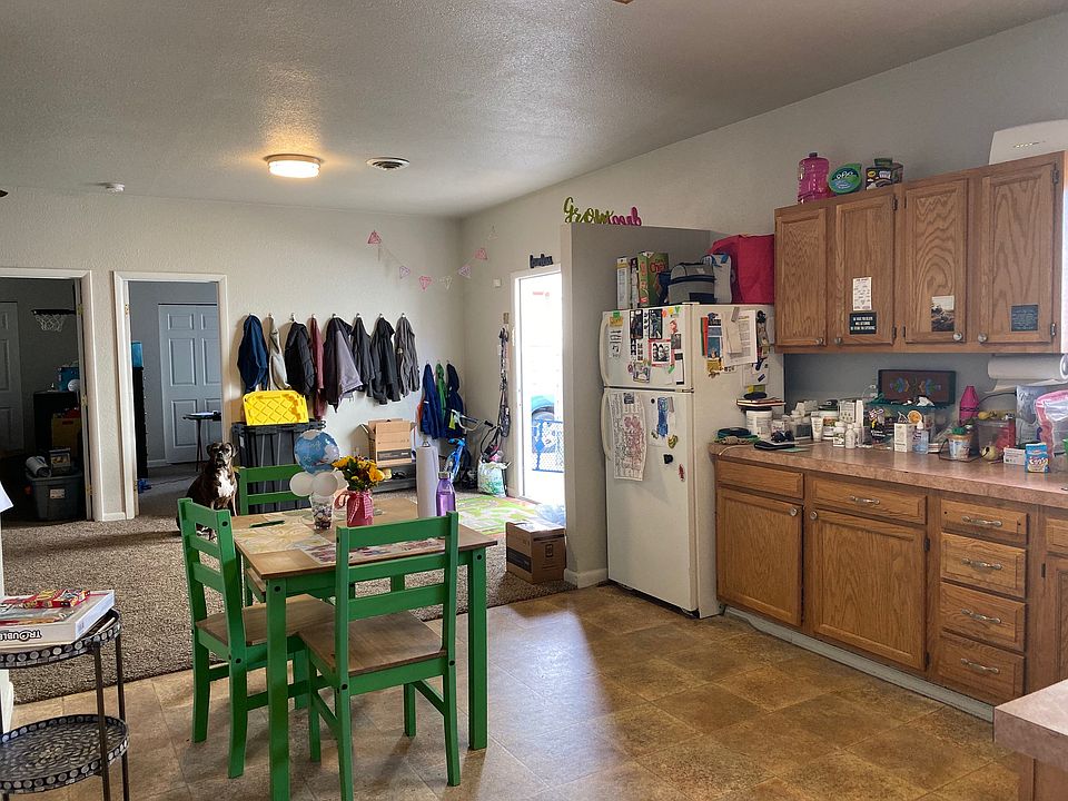 Eat-in kitchen and view of living area from the kitchen. Also, view of bedroom 1 and 2 entrance.