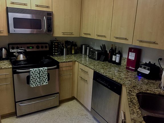 Fully furnished kitchen with granite countertops.