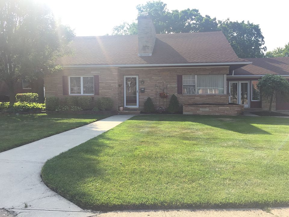 Gorgeous brick home with fully landscaped front yard with ir