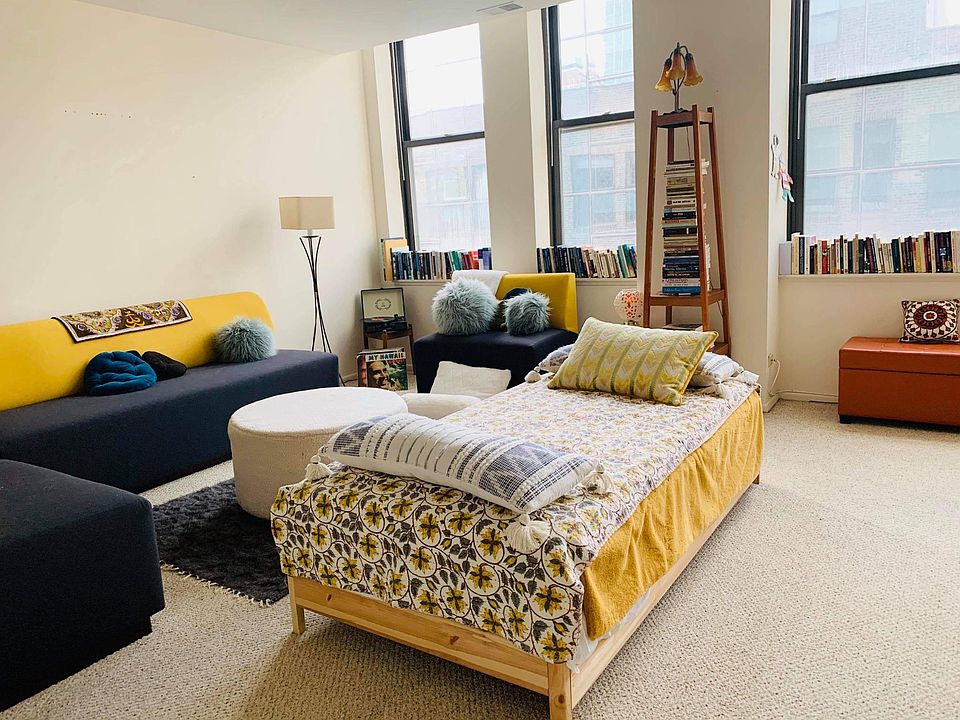 First floor open plan living area (pictured furniture: 3 piece modern sectional sofa, plush round "table" (or use as another seat), 2 stacked single beds become a comfy chaise