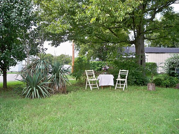 Large Double Lot Features Shaded Quiet Corner With Landscaping to Relax