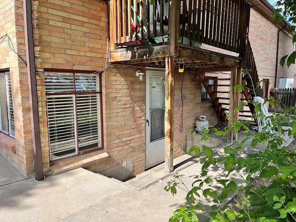 Front door below neighbor's deck