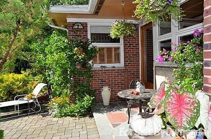 covered porch entry : natural slate floor, private alfresco dining area