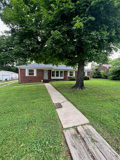 Large front yard with mature trees