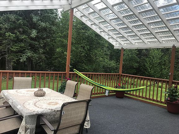 Large covered deck with table and hammock.