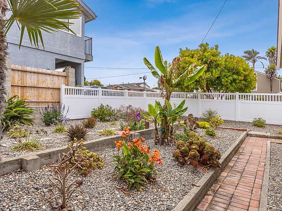 Fenced and landscaped backyard.