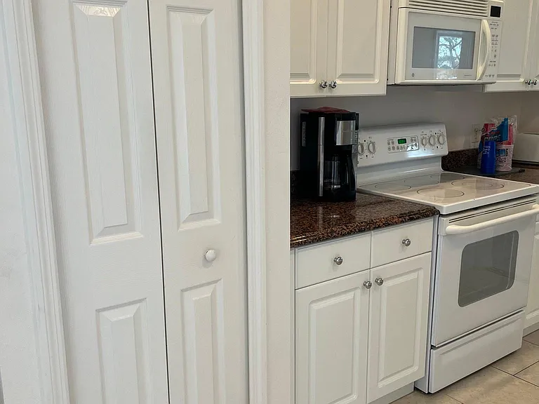 Microwave on top of stove. All electric home.