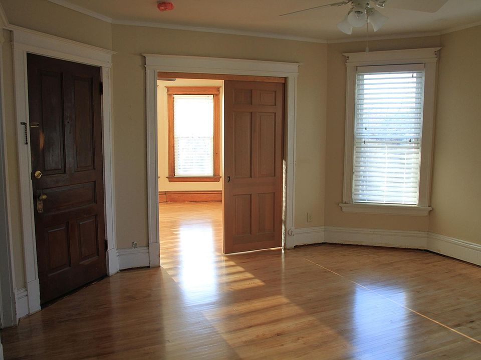 Door to front hallway into living room looking into master bedroom or office.
