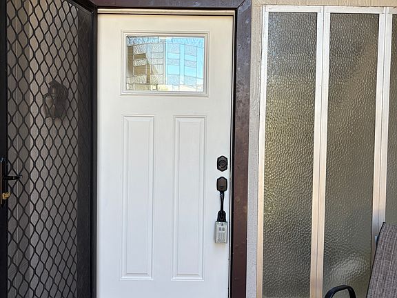 Front entry door freshly painted white.