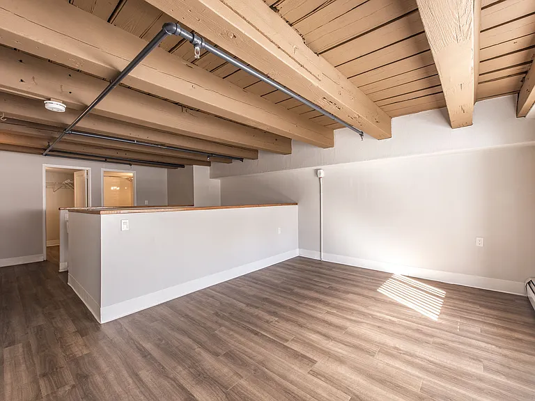 Lofted Bedroom With Wooden Flooring