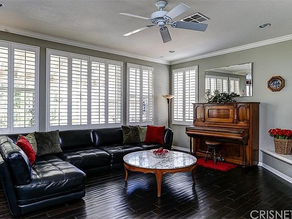 FAMILY ROOM:  Wood floors, wall of windows/plantation shutters, crown molding throughout