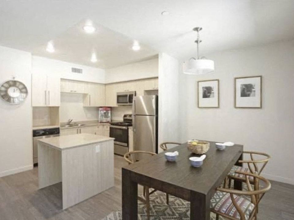Dining room and kitchen in apartment at City Plaza Apartments in Escondido, California.