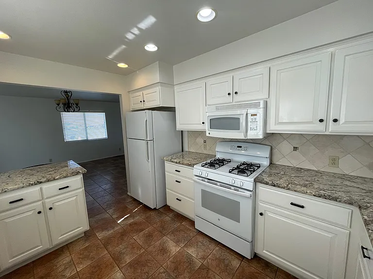 Kitchen comes with gas stove & range, refrigerator, dishwasher & microwave.