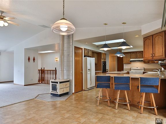 Open living area with wood stove that heats the entire upstairs.