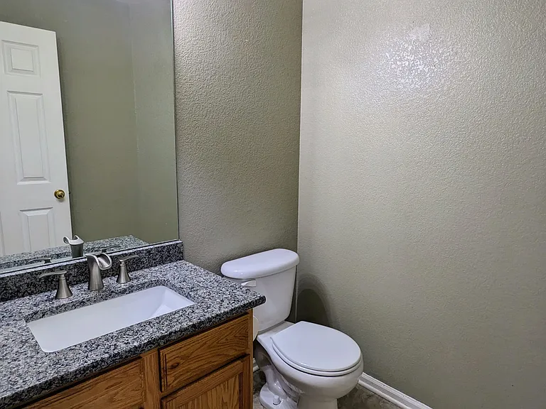 Main-level powder room, with tile and granite