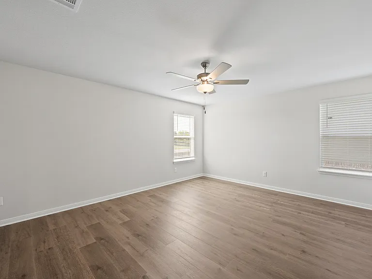The master bedroom has two large windows that let in great, natural light.