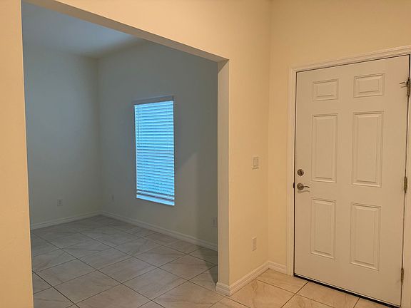 Front door with entrance to bonus room