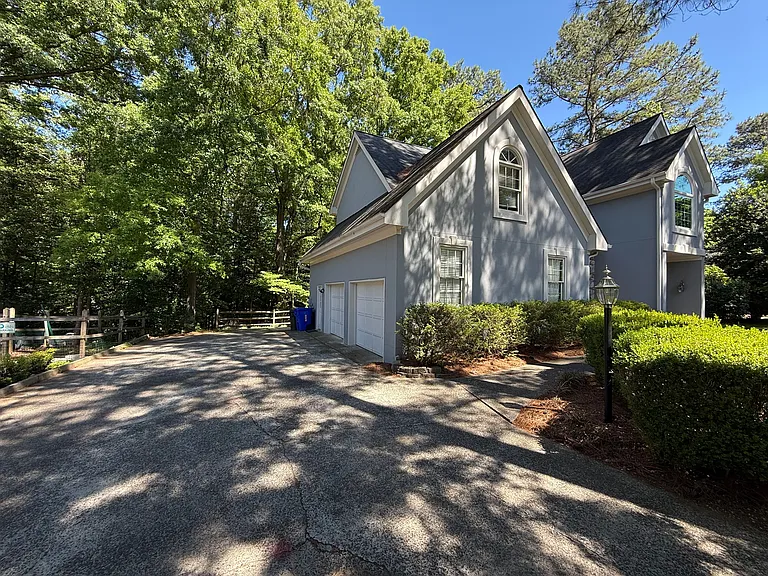 Side view: driveway, 2-car garage