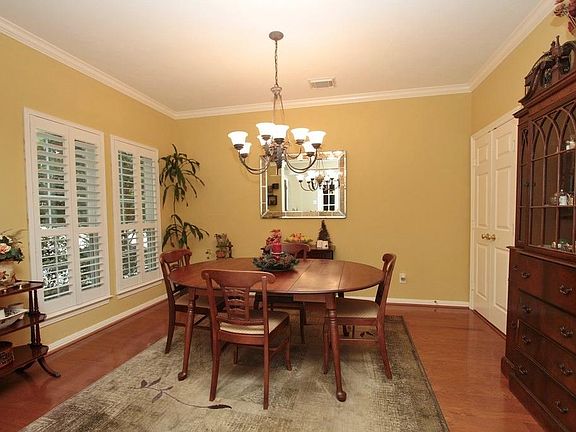 The Formal Dining Room features lovely decorator colors that contrast beautifully with the crown molding, hardwood floors and Plantation shutters.