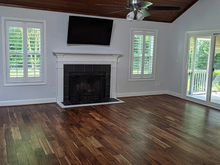 gas burning logs and vaulted ceiling in living room; plantation shutters throughout
