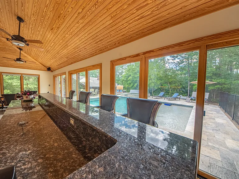 Pool room with bar, overlooking pool.