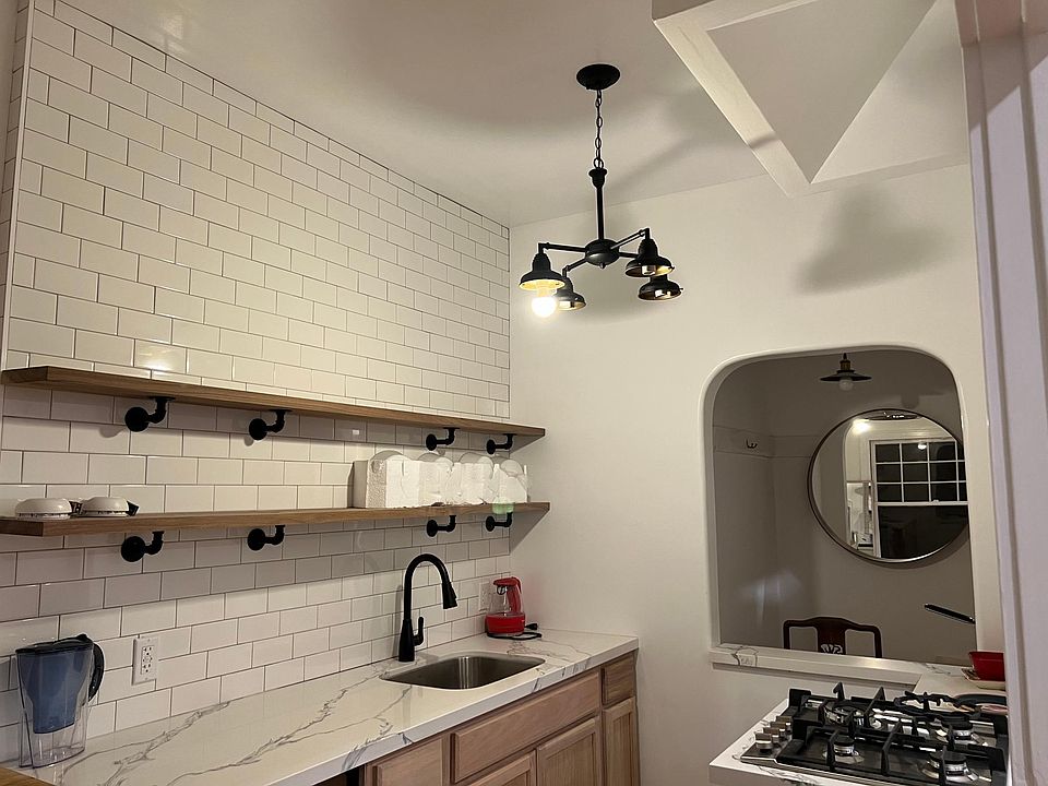 New fixture has schoolhouse light globes, peek-a-boo window to writing nook.