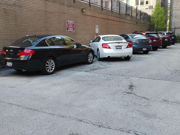 7 spot parking lot next to courtyard gate entrance.